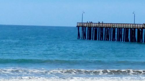 Pier on sea against clear sky