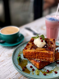 Close-up of french toast with beetroot smoothie and a cup of coffee