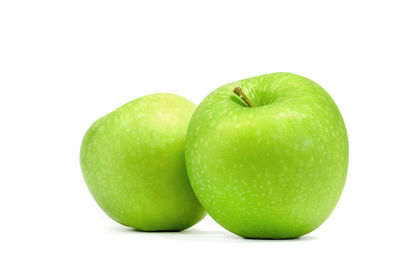 Close-up of fresh green apple against white background