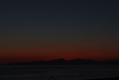 Scenic view of sea against romantic sky at sunset