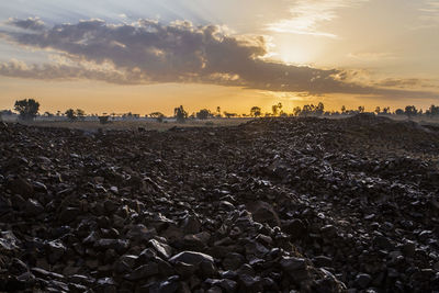 Scenic view of land against sky during sunset