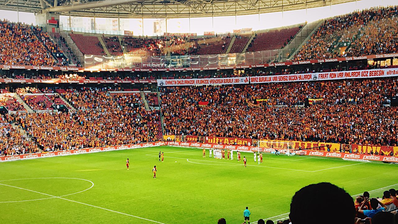 CROWD ON SOCCER FIELD IN CITY