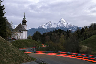 Road amidst buildings against sky