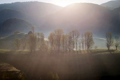 Scenic view of mountains against bright sun