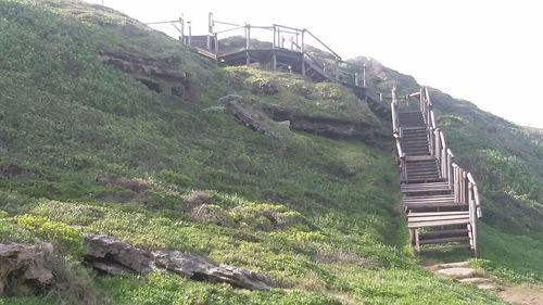 Low angle view of bridge leading towards mountain