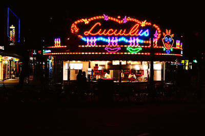 Illuminated amusement park at night