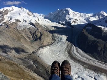 Low section of person on snowcapped mountain