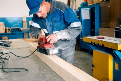 Midsection of man working in workshop