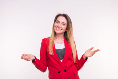 Portrait of a smiling young woman against white background