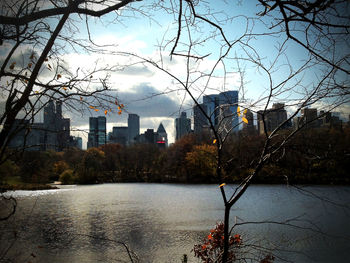 City by river against sky