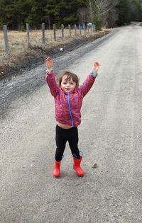 Full length of girl standing on road