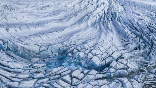 From above rough surface of vatnajokull glacier with cracks in wild volcanic terrain as abstract background