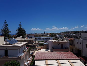 High angle view of townscape against blue sky