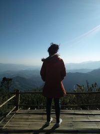 Rear view of woman standing mountains