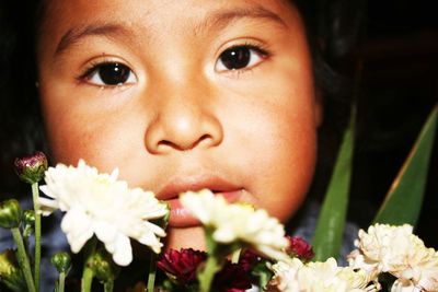 Close-up portrait of smiling girl with flowers