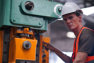 Midsection of man working in factory