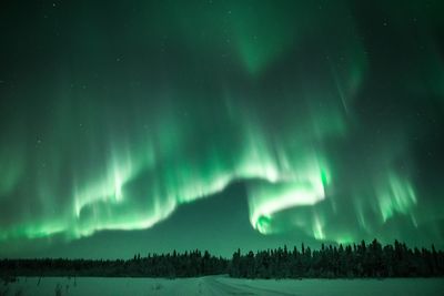 Scenic view of landscape against sky at night