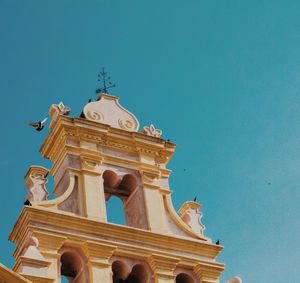Low angle view of temple against clear blue sky