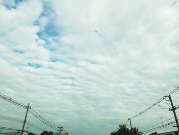 Low angle view of electricity pylon against sky