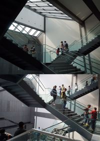 People walking on staircase in city