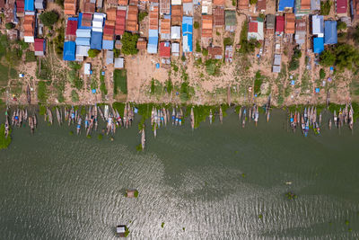 Aerial view of houses by sea in town