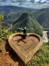 Rear view of man standing on mountain