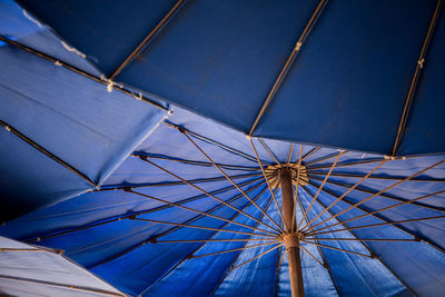 Low angle view of blue umbrella