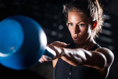 Athlete exercising with weights in gym