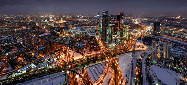 High angle view of city lit up at night