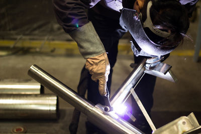 Man welding metal at factory