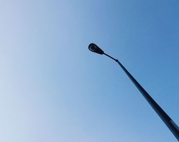 Low angle view of street light against clear blue sky