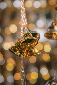 Close-up of bells hanging on string
