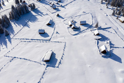 Snow covered remote village, homestead in the mountains. aerial drone view