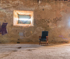 Empty chair in abandoned building