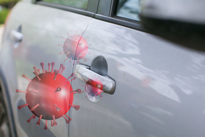 Close-up of red car on window