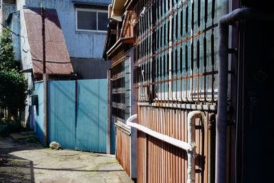 Buildings seen through metal fence