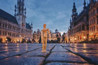 Surface level view of figurine at illuminated city square