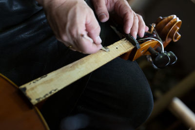 Close-up of man holding guitar