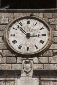 Low angle view of clock on wall