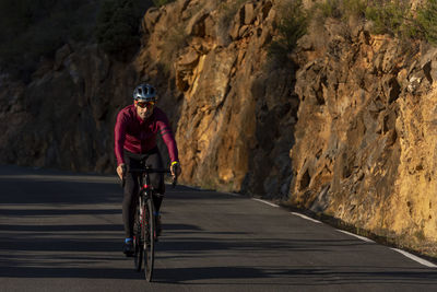 Full length of woman riding bicycle