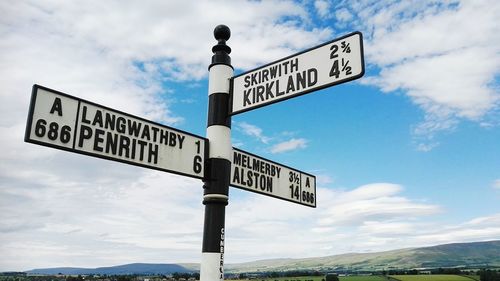 Low angle view of road sign against sky