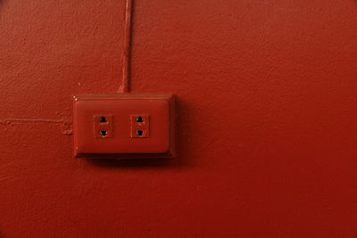 Close-up of red light on wall