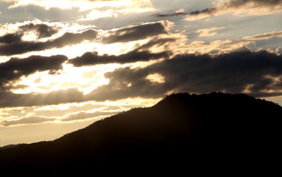 Scenic view of silhouette mountains against sky during sunset