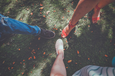 Low section of people standing on grass