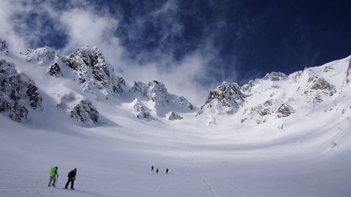 Panoramic view of snowcapped mountain against cloudy sky