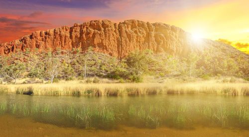 Scenic view of lake by mountain against sky