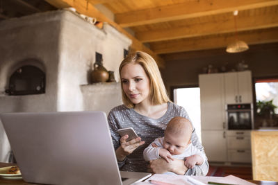 Woman using mobile phone in laptop