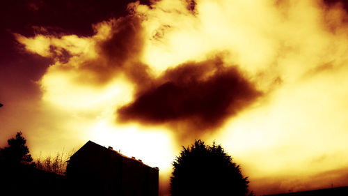 Low angle view of silhouette trees against sky at sunset