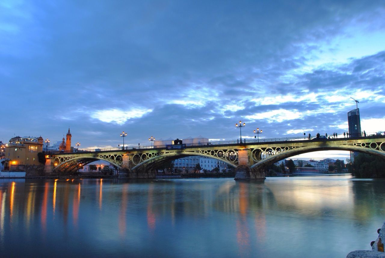 architecture, built structure, water, connection, bridge - man made structure, waterfront, river, reflection, sky, bridge, building exterior, cloud - sky, arch bridge, transportation, city, engineering, cloud, arch, outdoors, no people