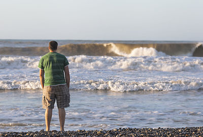 Rear view of man looking at sea